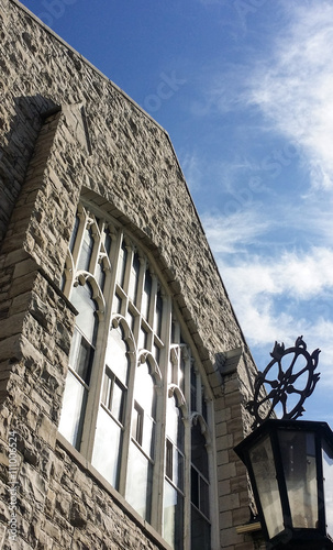 Greystone church building with street light in front photo