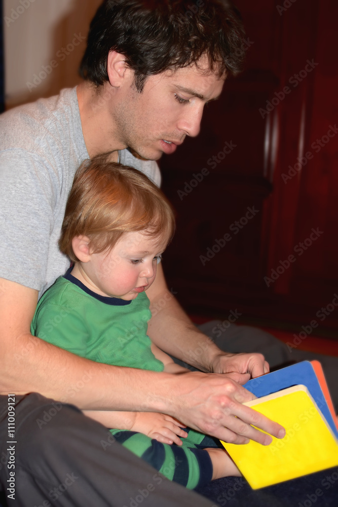 father reading son story at bedtime father reading son story at bedtime