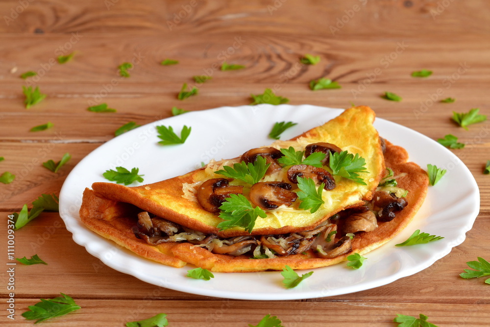 A delicious omelet with mushrooms, cheese and parsley. Stuffed omelet. Eggs recipe A delicious omelet with mushrooms, cheese and parsley. Stuffed omelet. Eggs recipe