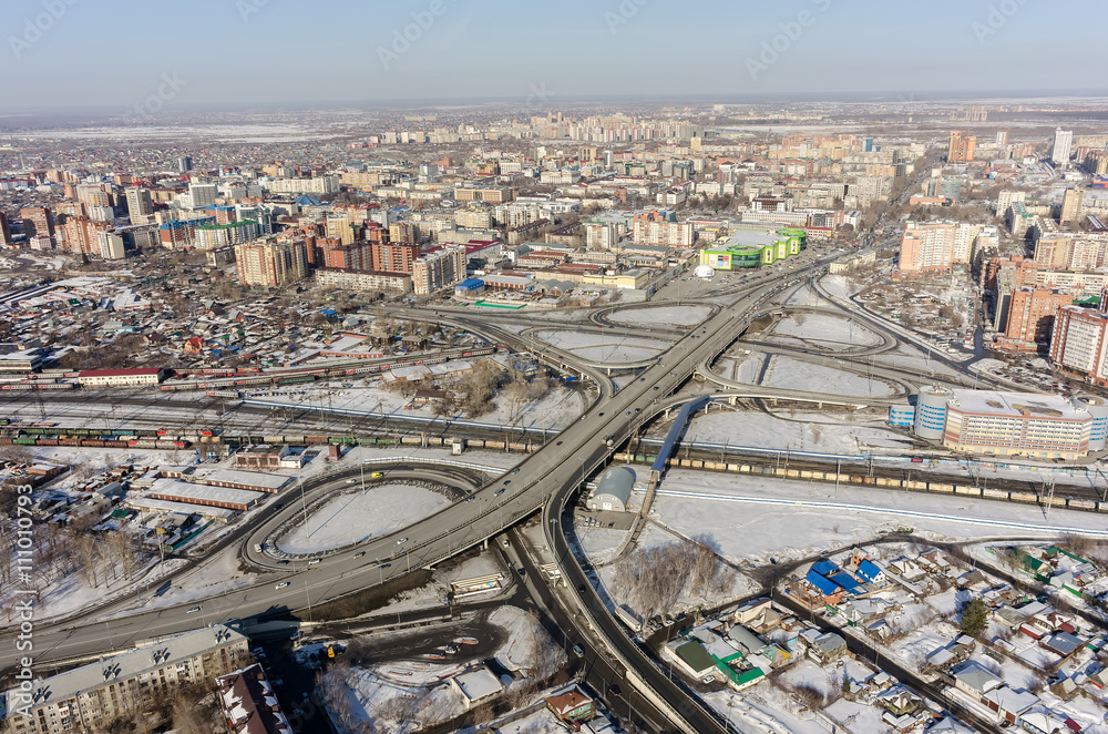 Tyumen, Russia - March 11, 2016: Bird eye view onto road intersection over railways