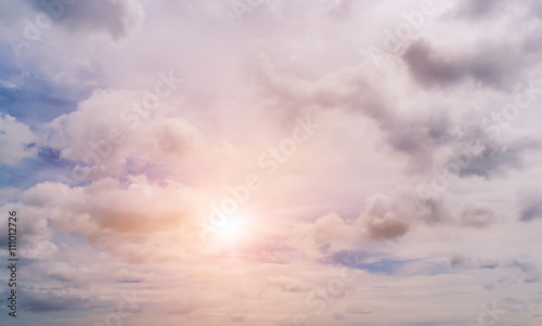 Blue sky with clouds and sun.