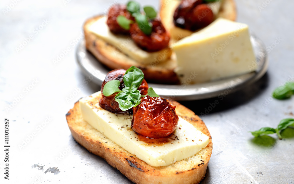 toast with cheese, tomato and basil on a light background toast with cheese, tomato and basil on a light background