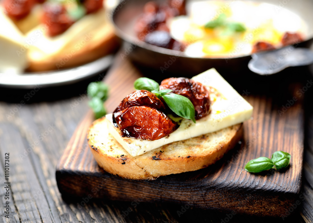 toast with cheese, tomato and basil on a wooden background toast with cheese, tomato and basil on a wooden background