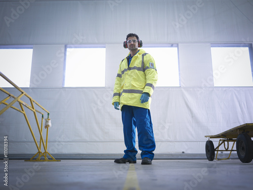 Portrait of airside engineer in aircraft maintenance factory photo