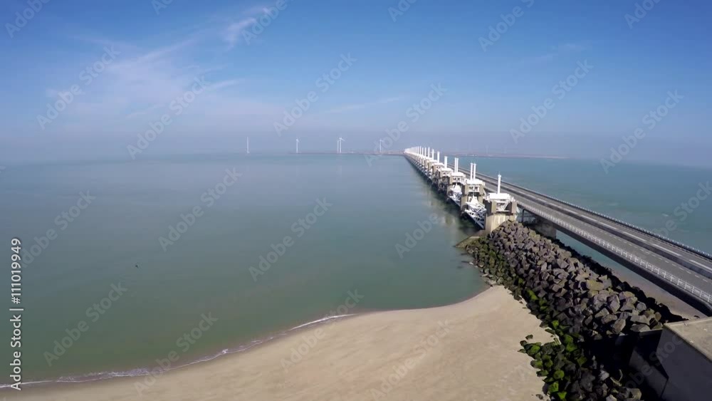 Aerial gaining altitude at beach side of Oosterscheldekering part of Delta Werken largest of 13 Delta Works dams and barriers in English Eastern Scheldt storm surge barrier Netherlands 4k Deltaworks Aerial gaining altitude at beach side of Oosterscheldekering part of Delta Werken largest of 13 Delta Works dams and barriers in English Eastern Scheldt storm surge barrier Netherlands 4k Deltaworks
