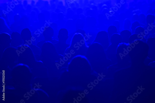 People watching a beautiful laser show. Defocused image