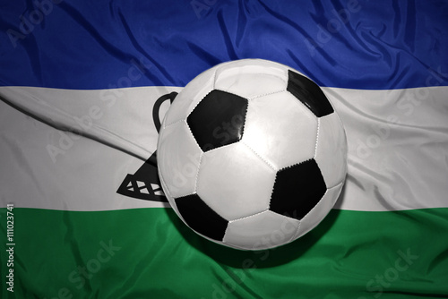 black and white football ball on the national flag of lesotho