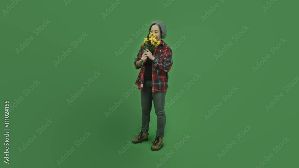 caucasian casual girl isolated on green screen smelling flowers caucasian casual girl isolated on green screen smelling flowers