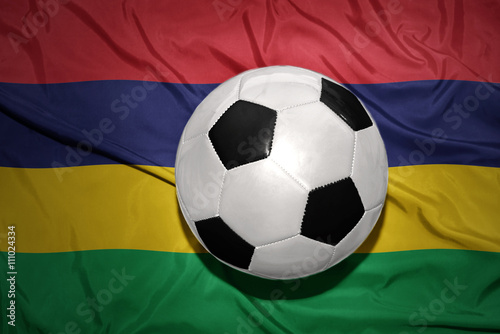black and white football ball on the national flag of mauritius