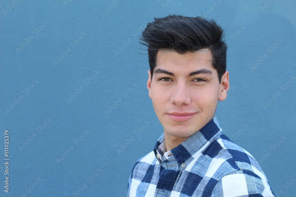 Handsome hispanic man with a perfect white smile isolated on a blue background with copy space