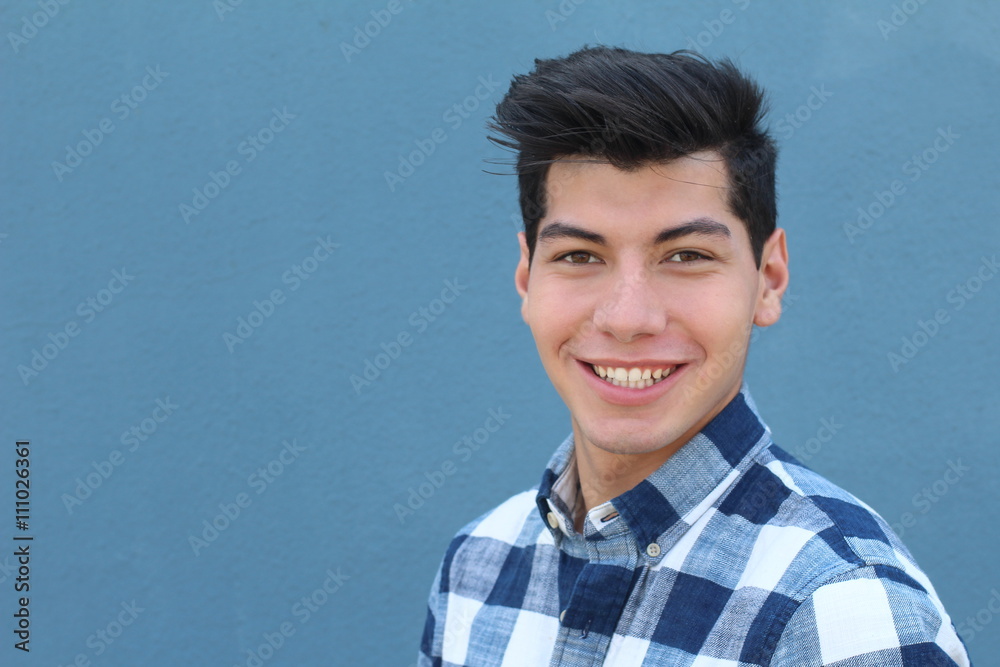 Handsome hispanic man with a perfect white smile isolated on a blue background with copy space Handsome hispanic man with a perfect white smile isolated on a blue background with copy space
