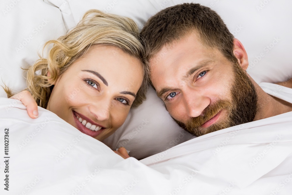 Portrait of couple smiling on bed Portrait of couple smiling on bed