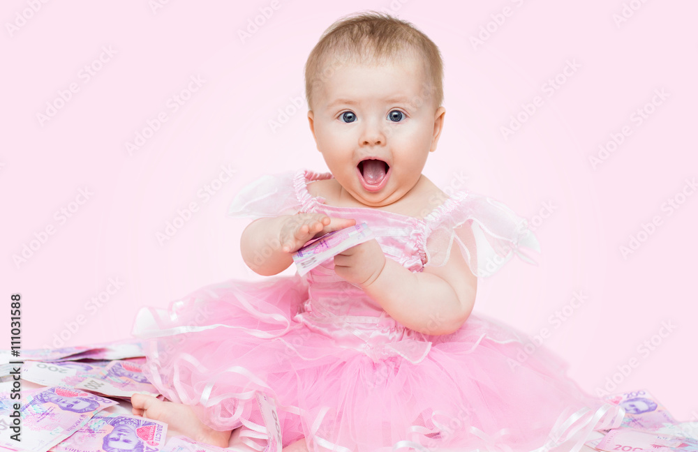 Surprised baby girl playing with money, on pink background. Surprised baby girl playing with money, on pink background.