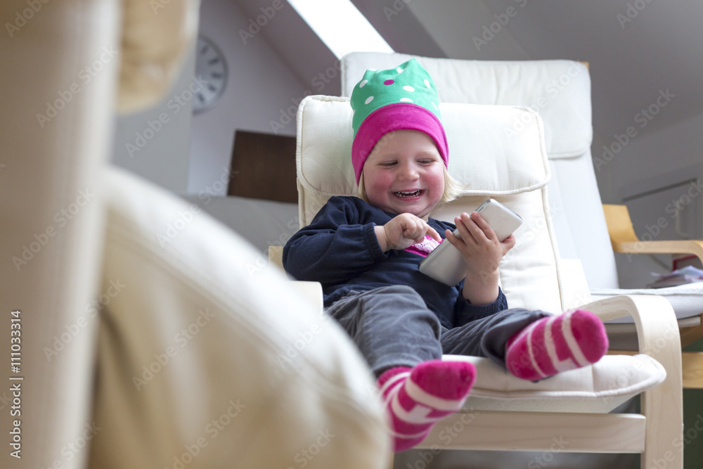 Toddler having fun with smartphone at home Toddler having fun with smartphone at home