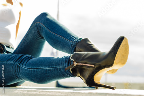 woman legs in denim pants heels shoes outdoor photo