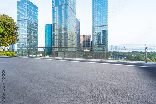 empty asphalt road near modern office building