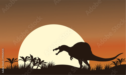 Silhouette of spinosaurus and big sun