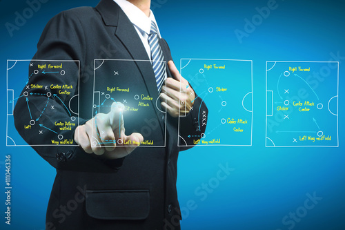 Plan of soccer manager pointing to strategy tactical board photo