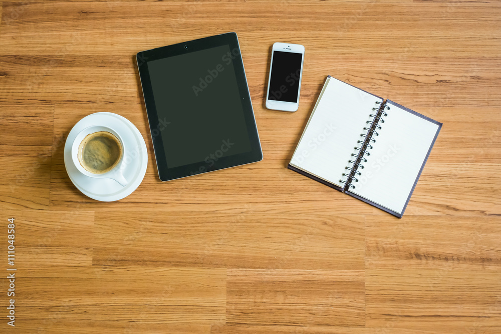 tablet, smart phone, coffee and note on the wood table tablet, smart phone, coffee and note on the wood table