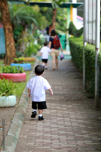 Young student walking to school by him self