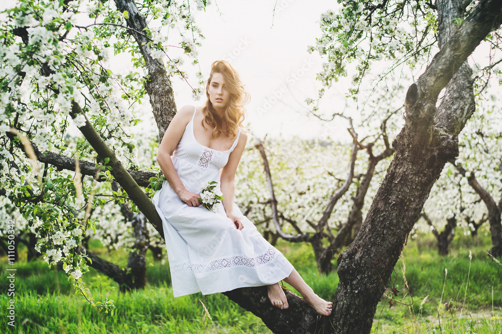 Portrait of beautiful romantic lady in apple trees blossoms Portrait of beautiful romantic lady in apple trees blossoms