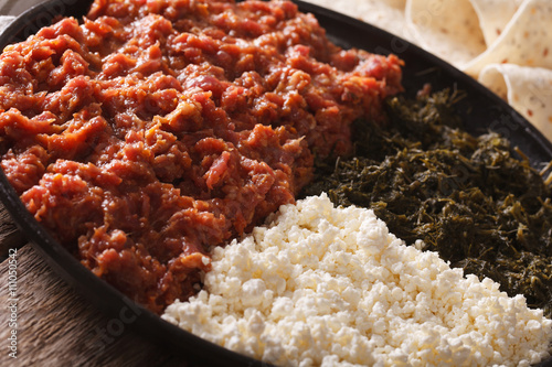 Ethiopian kitfo with herbs and cheese ayibe close-up. horizontal
 photo