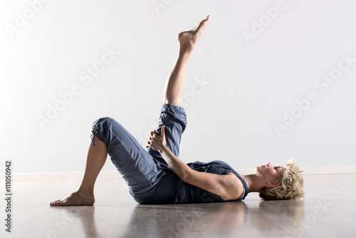 Woman on back stretching hamstring muscles
