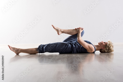 Woman holding knee while stretching hamstring