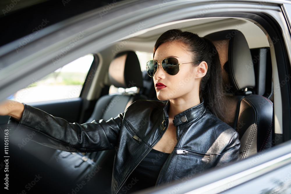 Confident woman in sunglasses driving to work