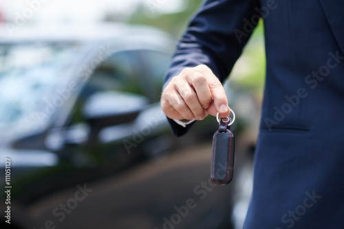 Close-up image of man giving you keys of his car © DragonImages