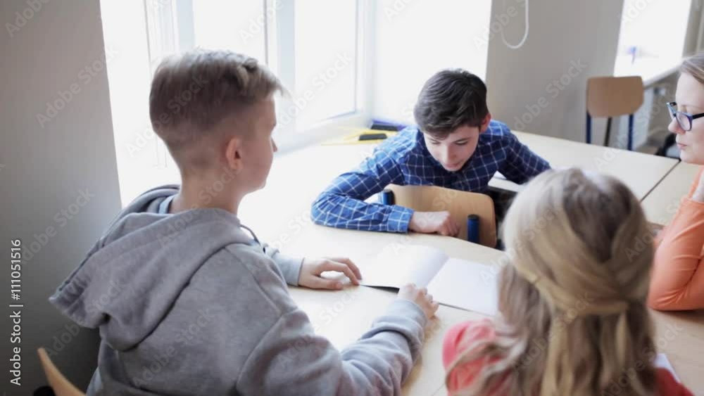 students with notebooks on lesson at school students with notebooks on lesson at school