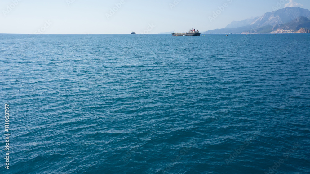 Blue sea with ships on horizon