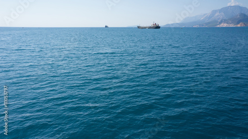 Blue sea with ships on horizon