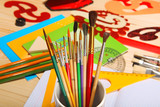 Paint brushes on background of stationery. Selective focus