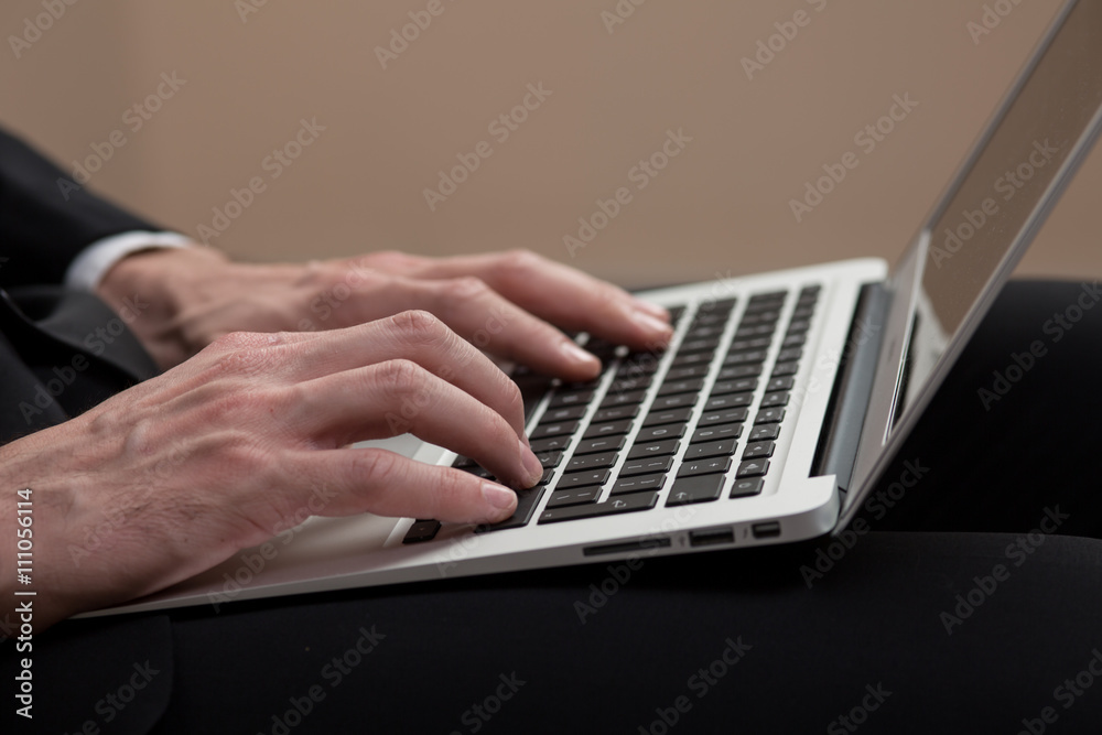 Young business man with a laptop in a studio Young business man with a laptop in a studio