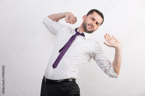 Business man stretches his back and arms