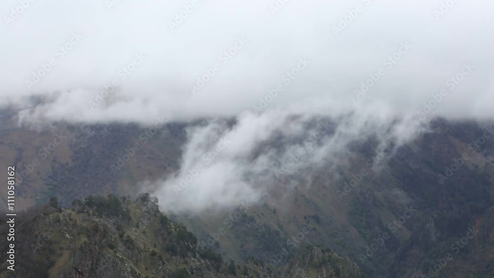 Russia. In early spring the dense veil of mist and clouds creeping up the steep mountain slopes of the Central Caucasus peaks. Russia. In early spring the dense veil of mist and clouds creeping up the steep mountain slopes of the Central Caucasus peaks.