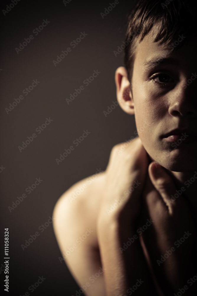 Serious Teenage Boy Holding Neck with Hands Serious Teenage Boy Holding Neck with Hands