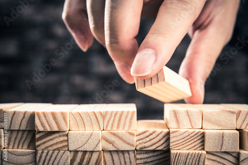 木製のブロックを積み上げている手 photo