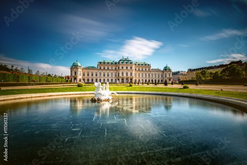 View on Upper Belvedere palace with fontain in Belvedere historic building complex in Vienna. Long exposure technic with blurred clouds and glossy water