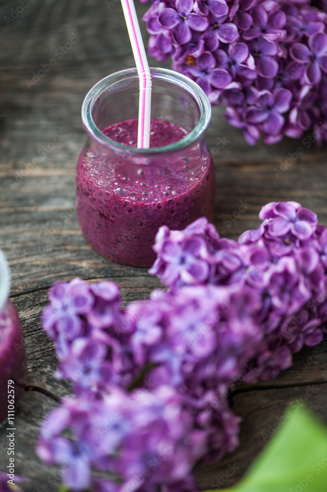 Blueberry smoothie in small glasses on a wooden table Blueberry smoothie in small glasses on a wooden table