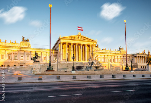 Austrian parliament building with Athena statue on the front in Vienna on the sunrise. Long exposure image technic with burred clouds