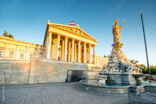 Austrian parliament building with Athena statue on the front in Vienna on the sunrise photo