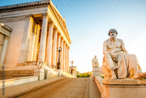 Photography Austrian parliament building with statue on the front in Vienna on the sunrise