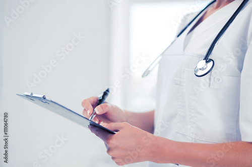 female doctor with stethoscope and prescription