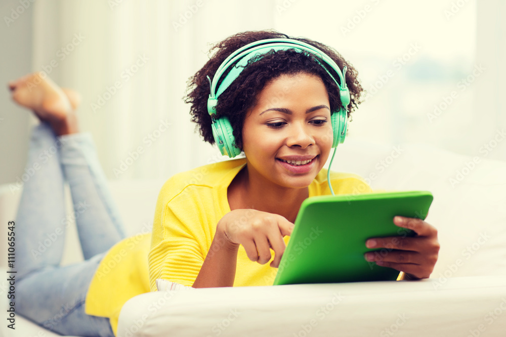 happy african woman with tablet pc and headphones happy african woman with tablet pc and headphones