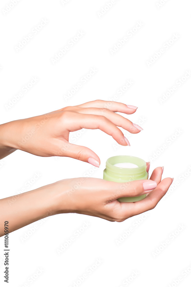 Female manicured hands holding cream jar isolated on white background Female manicured hands holding cream jar isolated on white background