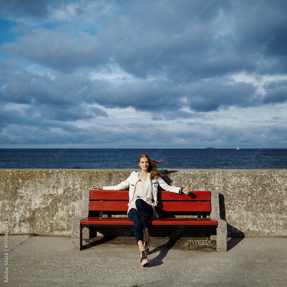 Fototapeta premium beautiful blonde woman sitting on bench