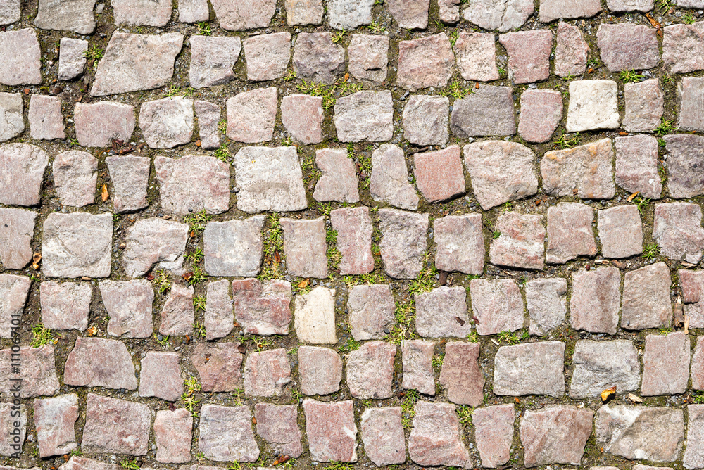 background of cobblestone with grass background of cobblestone with grass