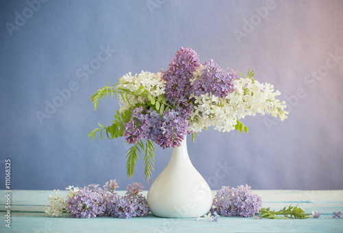 Fototapeta Naklejka Na Ścianę i Meble -  Still life with a blooming branch of lilac